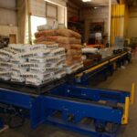 Heavy-duty conveyor system with pallets loaded for sterilization process, showcasing CHL Systems' custom design for industrial applications.