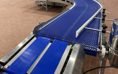 Industrial food-grade conveyor system with blue mesh belt, designed for efficient product movement in food manufacturing facilities.