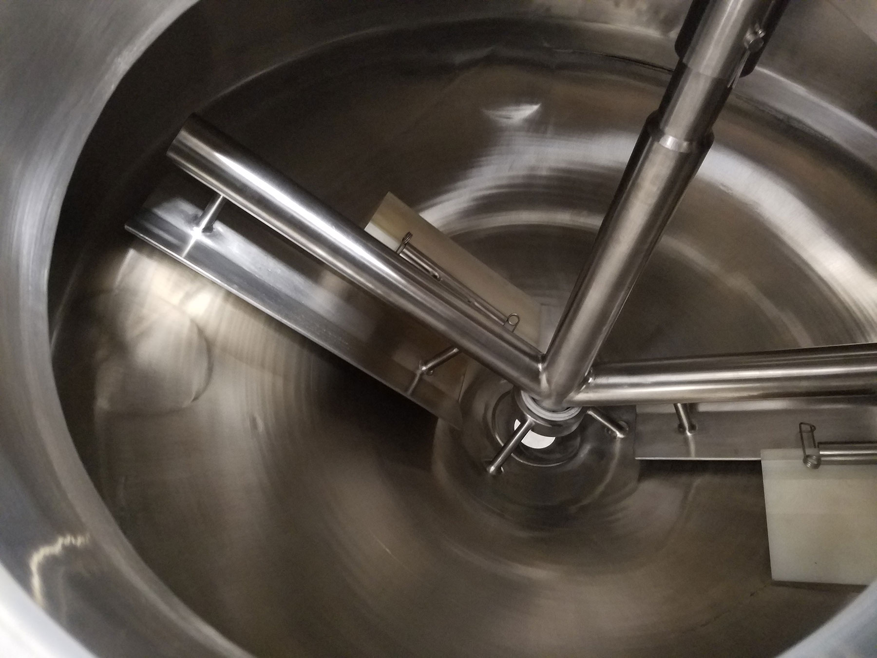 Batching tank mixer with stainless steel construction, featuring mixing blades and a central shaft, designed for food processing automation.