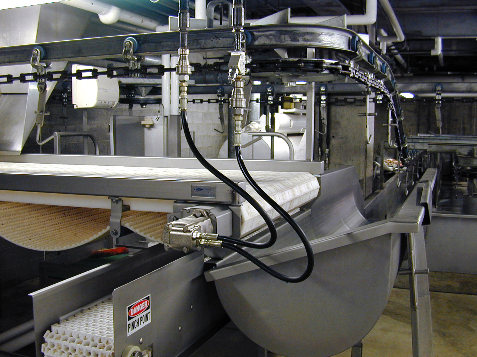 Inspection and wash system featuring stainless steel conveyor with integrated wash components, designed for food processing automation by CHL Systems.