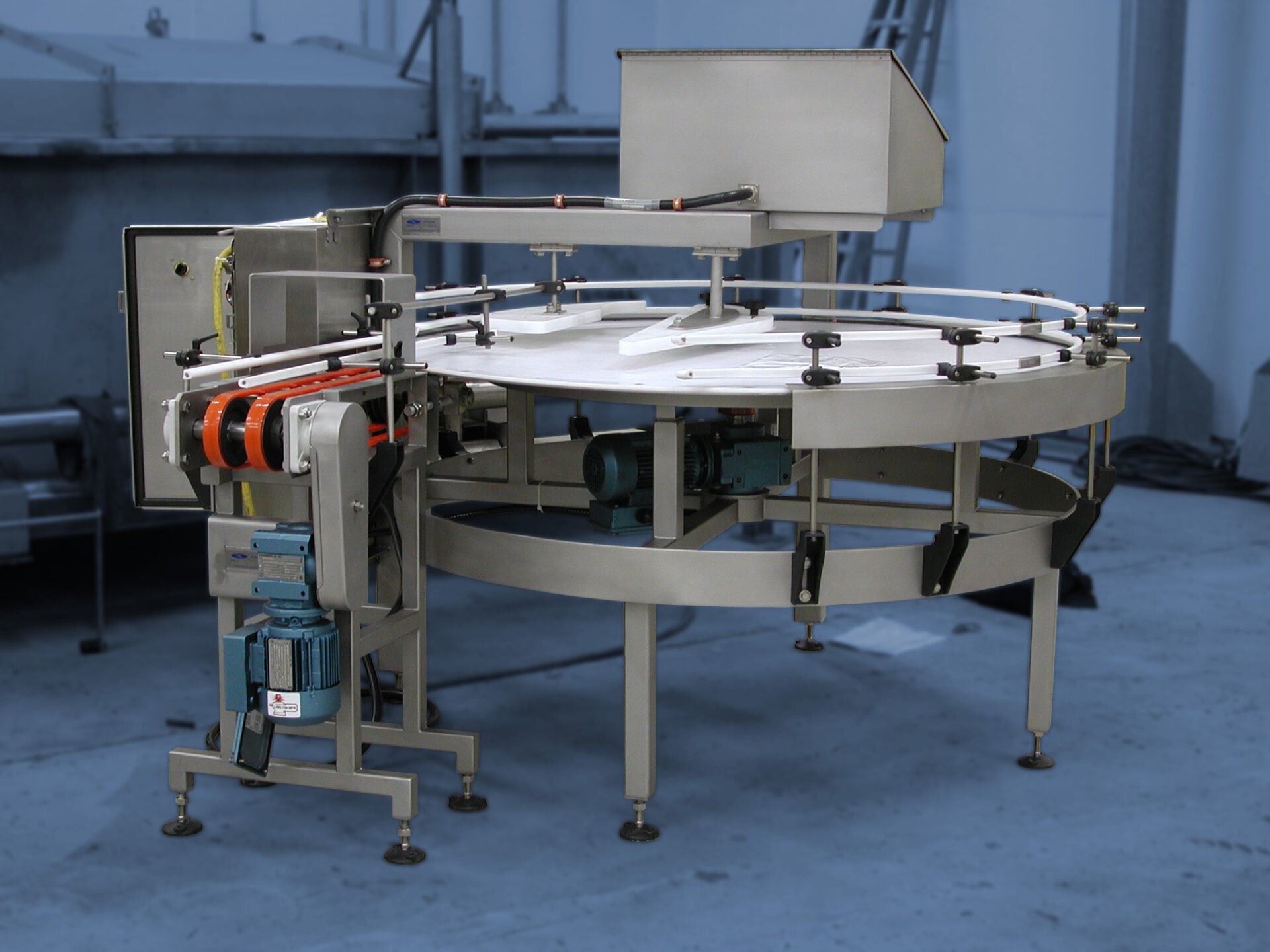 Labeling turntable for efficient product labeling in food processing automation systems, featuring a circular design and integrated motor components, set in an industrial environment.