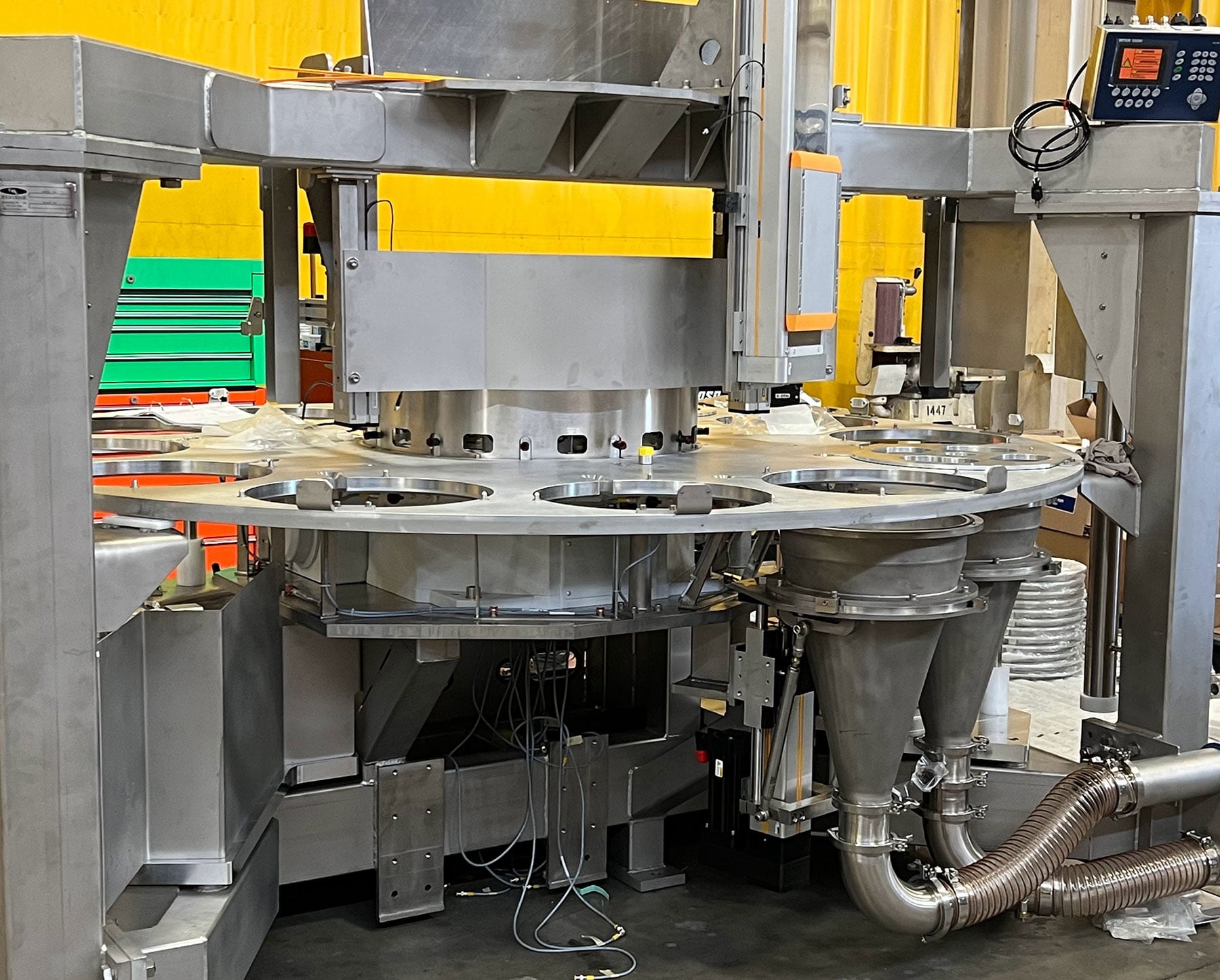 Rotary table processing equipment with multiple dispensing hoppers, designed for food production automation and material handling solutions by CHL Systems Inc.