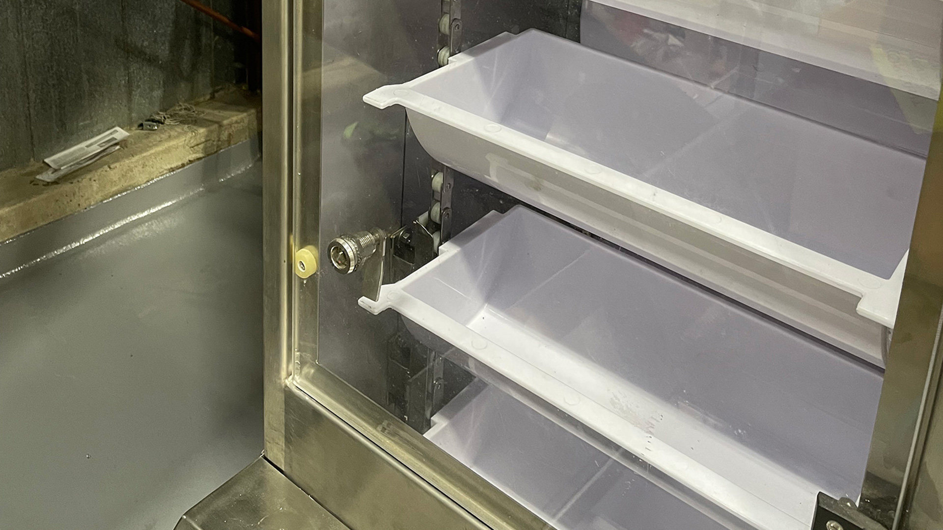 Bucket conveyor system with plastic buckets designed for transporting bulk materials in food processing environments.