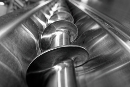 Screw conveyor with stainless steel spiral auger, designed for efficient material handling in food processing systems.