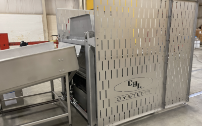 Industrial tote dumper by CHL Systems, showcasing stainless steel construction and perforated panels, designed for food processing automation and efficiency.