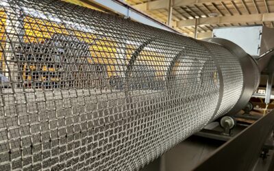 Industrial mesh conveyor system used in food production automation at CHL Systems facility.