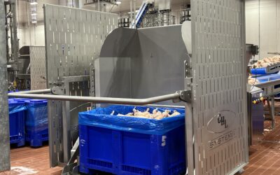 Dumper equipment for food processing, featuring a large blue container filled with poultry, designed for efficient material transfer in a processing facility.