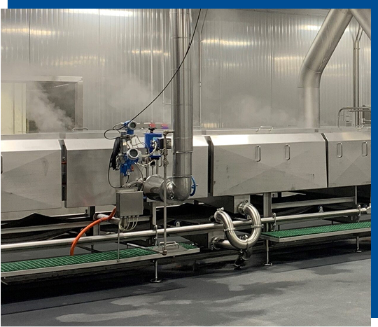 Automated steam cooker system with stainless steel construction, advanced steam distribution, and integrated cleaning features for pet food production.