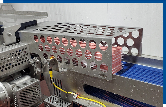 Automated patty handling system featuring stainless steel conveyor with patty slugs, designed for high-speed efficiency in food processing automation.