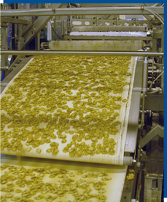 Innovative Cookie Curling System conveyor with custom-molded cookies, showcasing gentle handling and precise forming processes for food production efficiency.